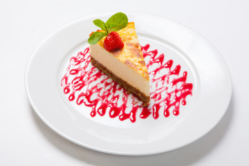 Cheesecake with fresh strawberries on white plate