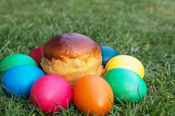 colored Easter eggs on the grass and kulichikah