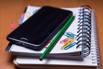 smartphote on notebook in office