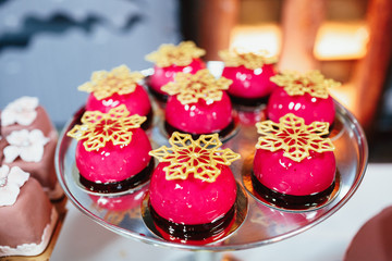 Red cakes decorated with golden snowflakes