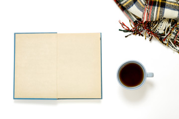 Cup of tea, book and wool blanket flatlay