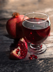Glass with pomegranate juice with sliced piece of pomegranate