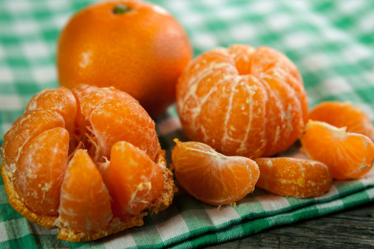 Peeled fresh clementines with kitchen cloth
