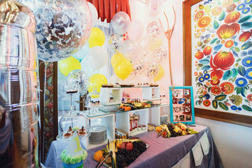 Violet table with sliced fruits and sweets
