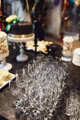 Crystal champagne flutes stand on black table