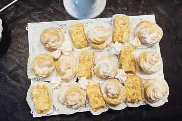 Look from above at tasty eclairs on white table