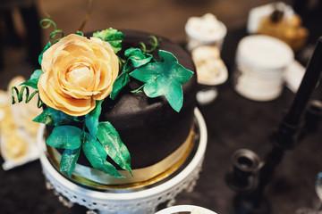 Golden rose decorated black cake