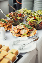 Bowls with salads and salty snacks