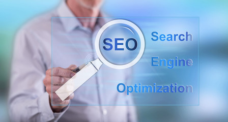 Man touching a seo concept on a touch screen