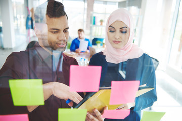 Business colleagues with sticky notes