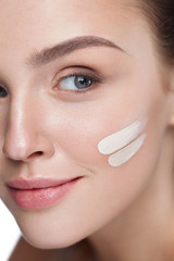 Facial Makeup. Skin Cream On Beautiful Sexy Woman Face