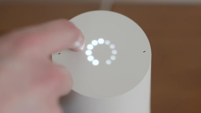 Man Adjusting Smart Home Voice Controlled Gadget Volume