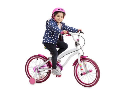 Little girl posing with a bicycle