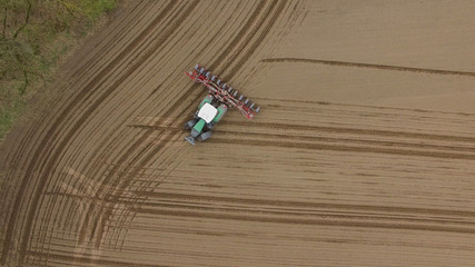 tractor - aerial view of a tractor at work - cultivating a field in spring - agricultural machinery