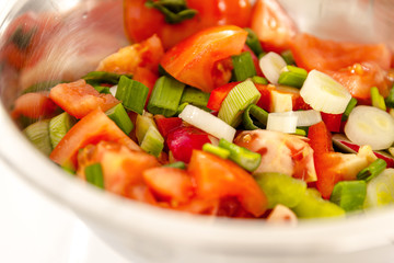 Fresh salad in a bowl. Tomato, onions, salad.