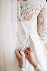 The groomsman helping to wear a butterfly for groom