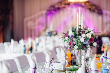 The vase with flowers and frame with number standing on the table