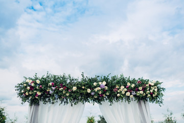 The different flowers hanging on the archway