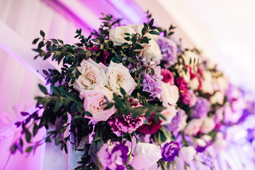 The different flowers hanging on the archway