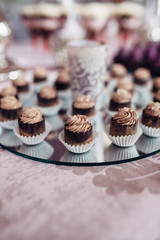 The cupcakes  standing on the buffet table