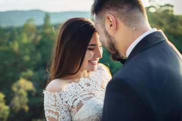The lovely couple in love embracing in the forest