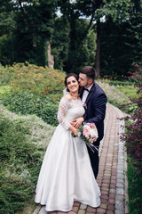 The charming brides embracing  in the park