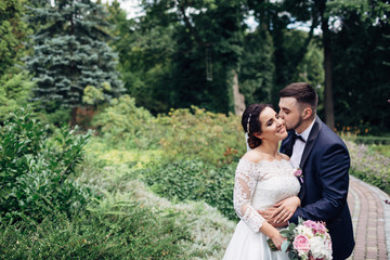 The charming brides embracing  in the park