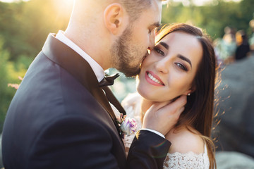 The lovely couple in love  embracing and standing   on the stones