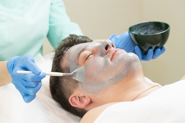 Man in the mask cosmetic procedure in spa salon