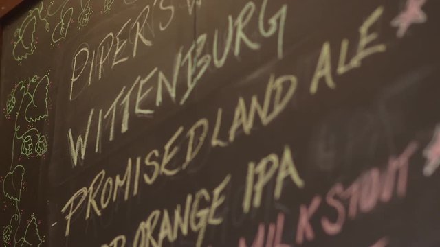 Craft Beer Chalkboard Menu with Decorative Artwork at Restaurant Bar / Brewery