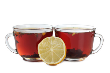 Glass cup with tea and lemon on white background