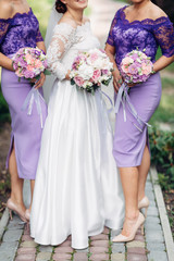 The bride with bridesmaids keeping bouquets