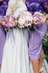 The bride with bridesmaids keeping bouquets