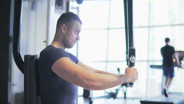 A young man is training in the gym. 4K