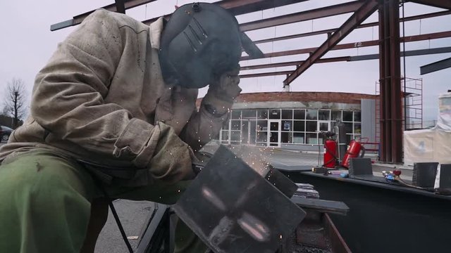 Welding of metal structures. Worker welds metal structural elements, welding machine. 60fps. Close-up.  

