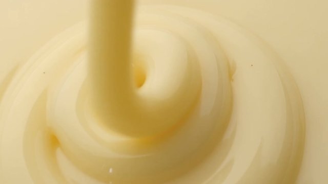 Pouring sweetened condensed milk. Close-up shot.
