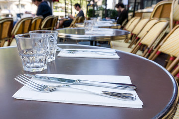 Street view of a coffee terrace with tables and chairs in europe