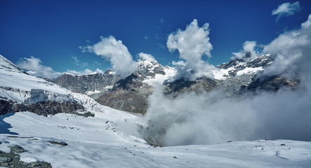 Fototapeta na wymiar Amazing View of the mountain range near the Matterhorn in the Swiss Alps. Snow capped mountains. Trek near Matterhorn mount.