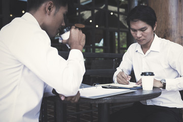 businessman discussing  strategy and planning  project to investment in overseas Branches at coffee cafe