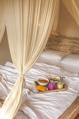 Healthy Raw Fruit Breakfast in Bed. Color Smoothie on Wicker Tray on White Sheet.