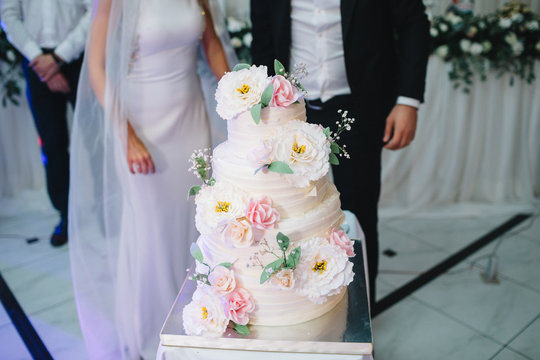 Gorgeous wedding cake decorated with large pink and white flowers