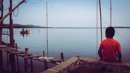 Kid watching the boat