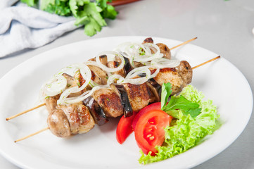 Skewers of grilled meat and vegetables on the white plate, restaurant menu, Selective focus, Close up