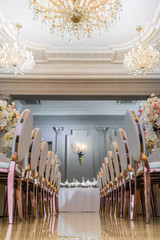 Look from below at chairs with golden legs at dinner table