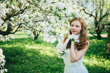 Obraz premium A girl in a blooming garden