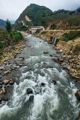 Water splashes on the rocks of mountain river