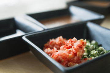 Close-up sauce cup shallots and green vegetable, food concept.