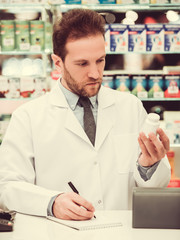 Handsome pharmacist at work