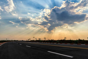 Fototapeta premium Picturesque landscape scene and sunrise above road.