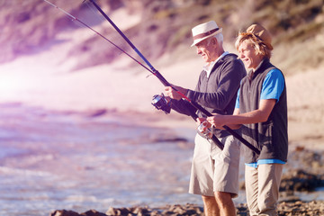 Senior man fishing with his grandson